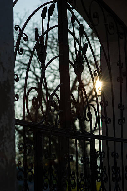 istock Sun shining through the bars of a wrought-iron gate 525754871