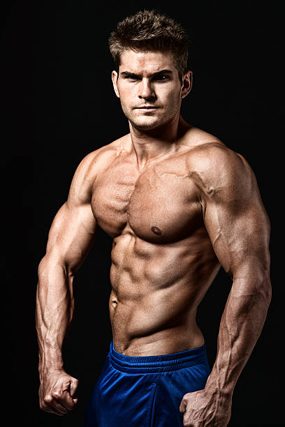 istock Shirtless muscular man in front of black background 525756211