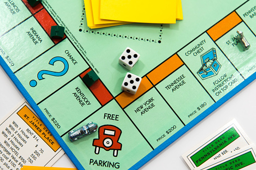 Houston, TX, USA - November 1, 2014: Monopoly board game - car on Free Parking and dice