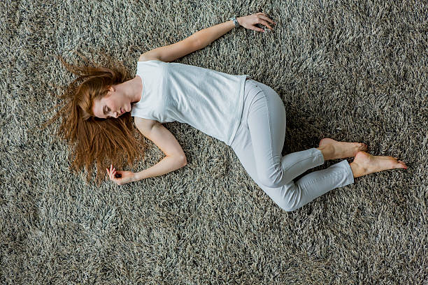 istock Young woman laying on the carpet 525770199