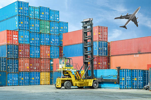 istock Crane lifter handling container box loading to truck 525770423