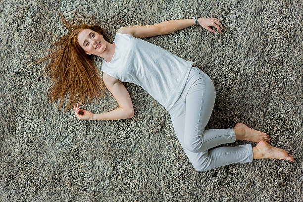 istock Young woman laying on the carpet 525770531