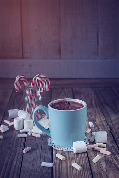 istock Mug filled with hot chocolat near marshmallow, toned image 525775575