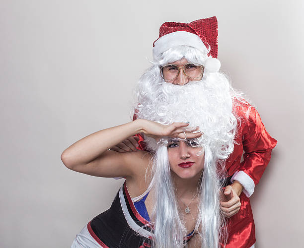 istock Santa Claus and girl playing with his beard 525791245