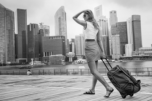 tourist adventure with suitcase in Singapore