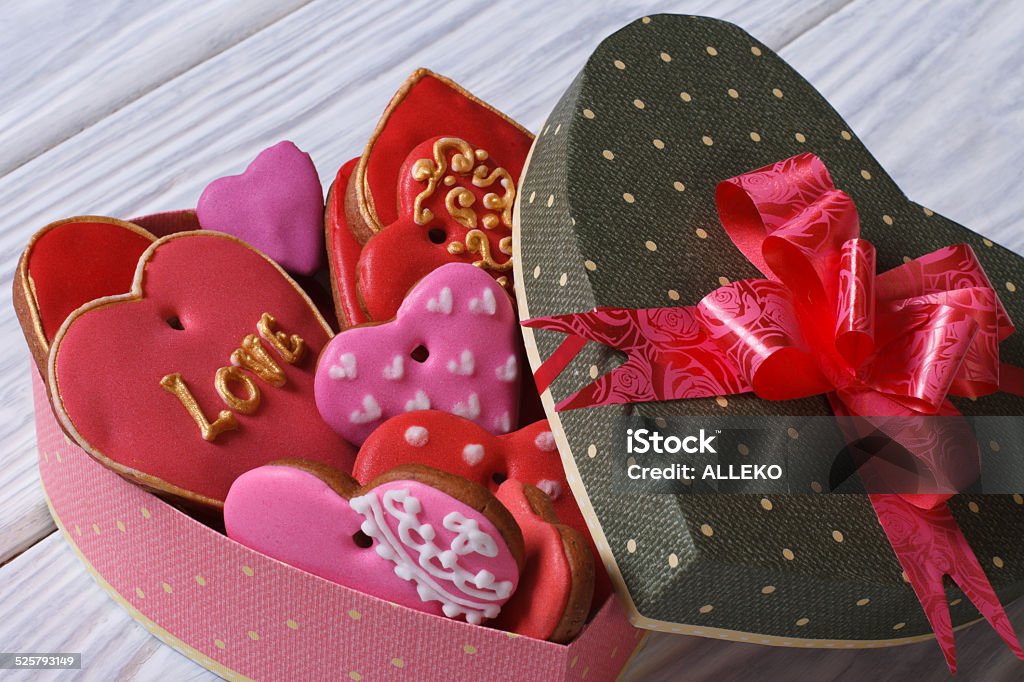 Colorful hearts biscuits in festive box with a bow Colorful hearts biscuits in festive box with a bow. Valentine's day holiday Baked Stock Photo