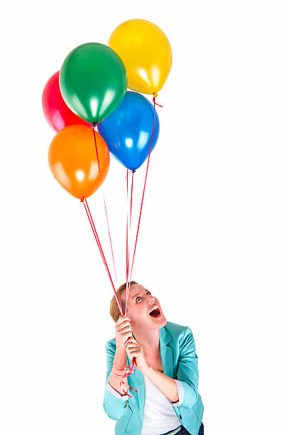 istock woman with balloons over white background smiling 525793795