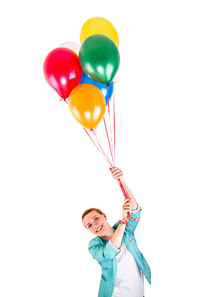 istock woman with balloons over white background smiling 525793799