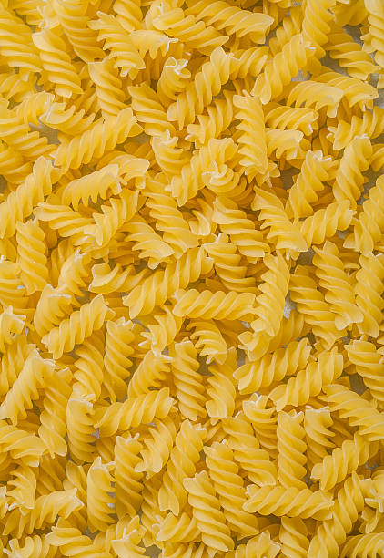 istock Spiral macaroni background food and drink concept 525800446