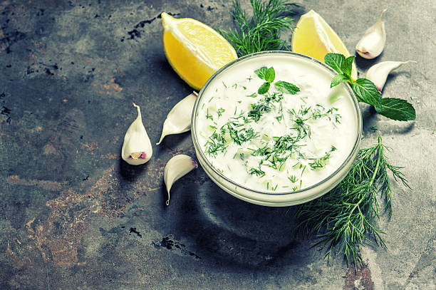 istock Tzatziki sauce Fresh dip Herbs dill mint yogurt vintage 525800518
