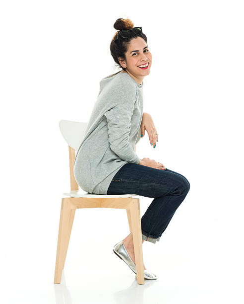 istock Smiling woman sitting on chair 525800522