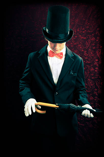 istock Boy Magician in Front of Wallpaper with Umbrella 525800788