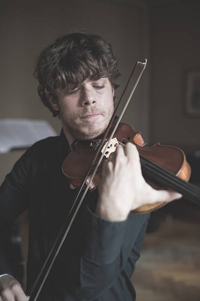 istock young handsome blonde violinist 525801189