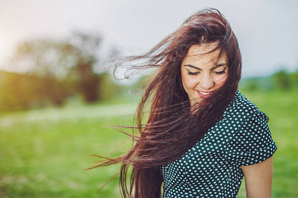 istock shy young beautiful woman in the wind 525801520
