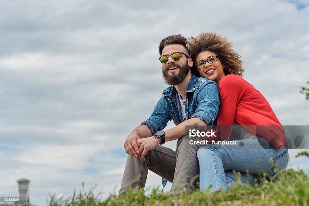 Beautiful young couple smiling at the park Beautiful portrait of two young people showing some affection in nature Couple - Relationship Stock Photo