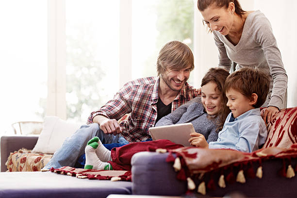istock Family relaxing, playing with digital tablet 525801763