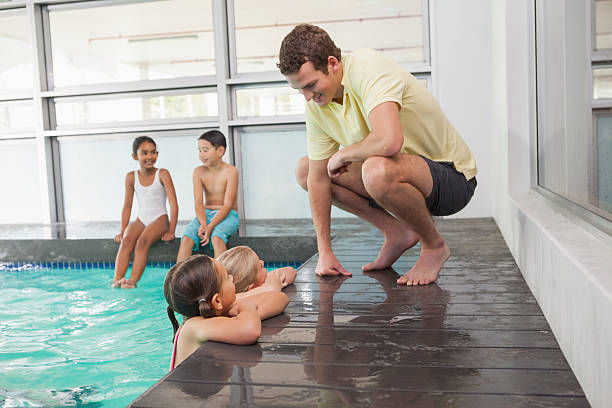 istock Cute swimming class listening to coach 525802413