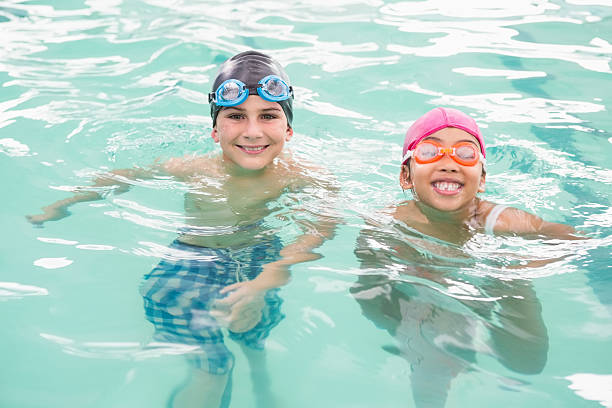 istock Cute swimming class in the pool 525802751