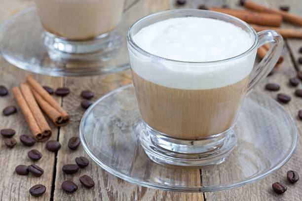 Coffee latte in glass cups on a wooden table Coffee latte in glass cups on a wooden table cappuccino coffee froth milk stock pictures, royalty-free photos & images