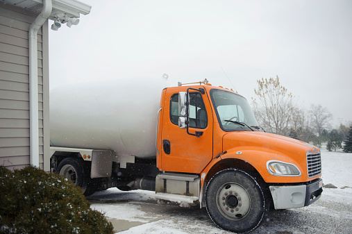 A propane truck sitting outside during winter.