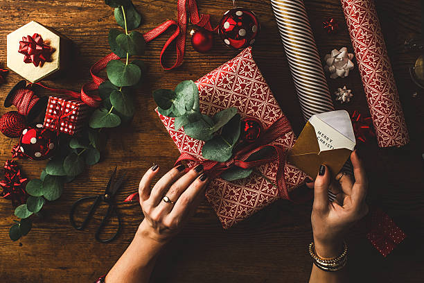 frau verpackung modernen weihnachts geschenke - einwickeln stock-fotos und bilder