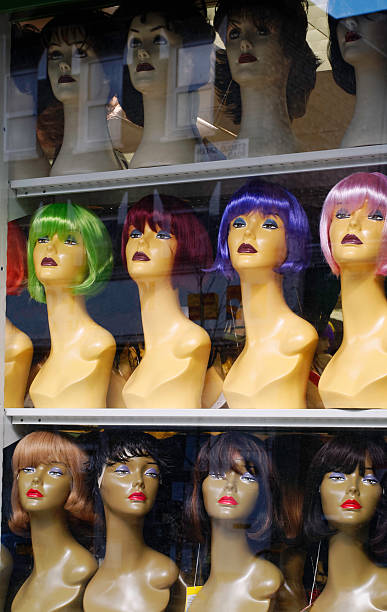 istock Female wig mannequins on display in a window 525806559