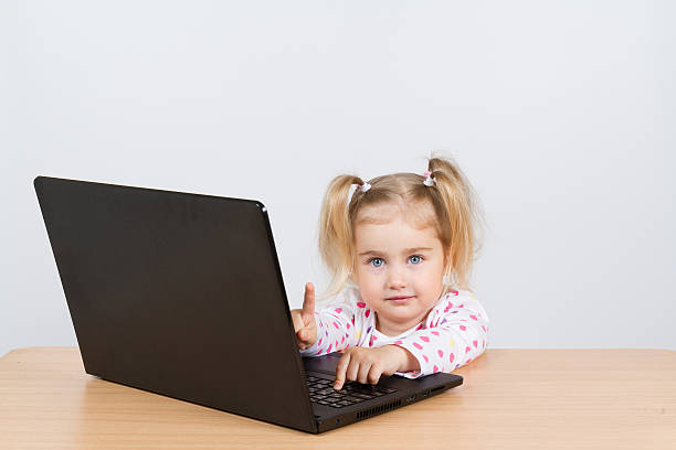 istock little girl at the computer. 525807154