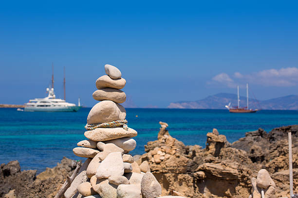 Stone figures on beach shore of Illetes beach in Formentera Mediterranean Balearic Islands