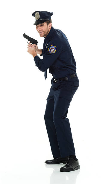 istock Cheerful police standing and holding gun 525808768