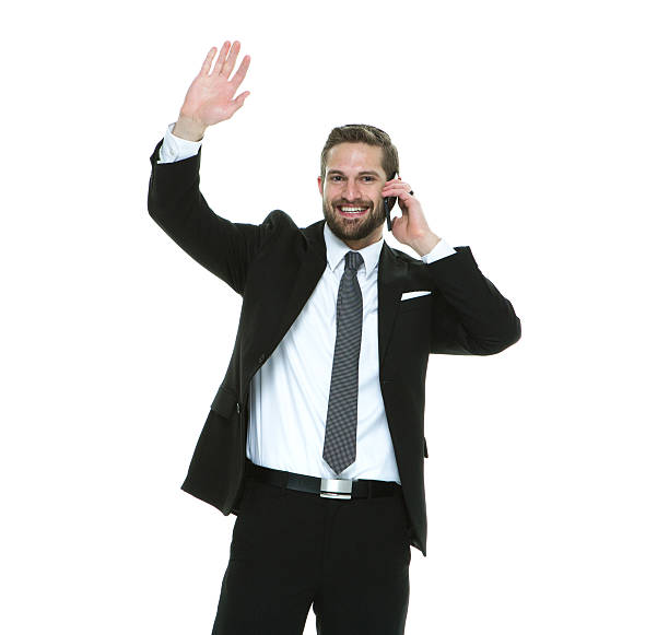 istock Cheerful businessman waving hand while on phone 525811226