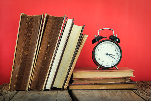 istock Still life of old books with alarm clock. 525811934