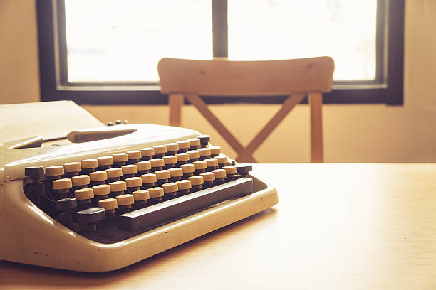 vintage typewriter on wooden desk stock photo