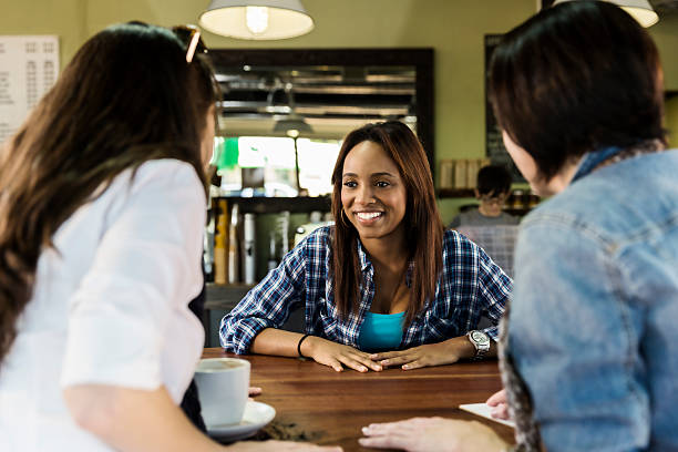 istock Three Girlfriends Enjoy Conversation Over a Cup of Coffee 525828453