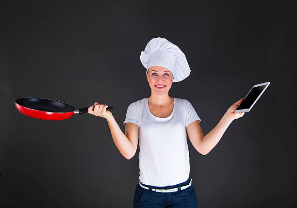 istock cooking, technology and food concept - smiling female chef, cook 525828749