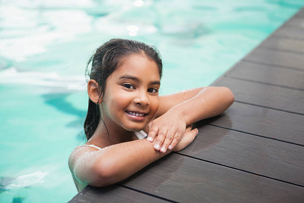 istock Cute little girl smiling in the pool 525829525