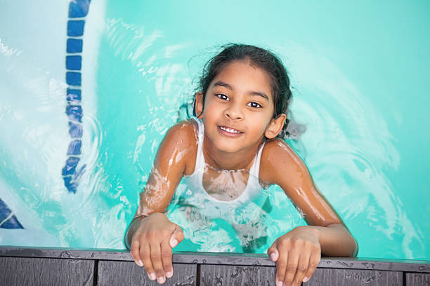 istock Cute little girl smiling in the pool 525829533