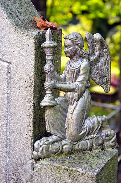istock angel with candlestick in old cemetery 525829593