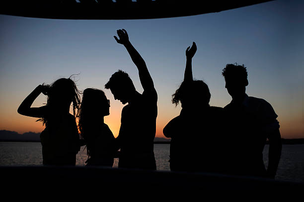 istock Silhouettes of people on a boat. 525829669