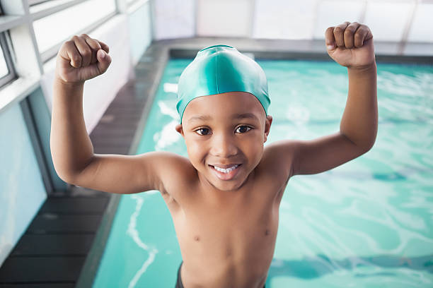 istock Cute little boy cheering at the pool 525830943