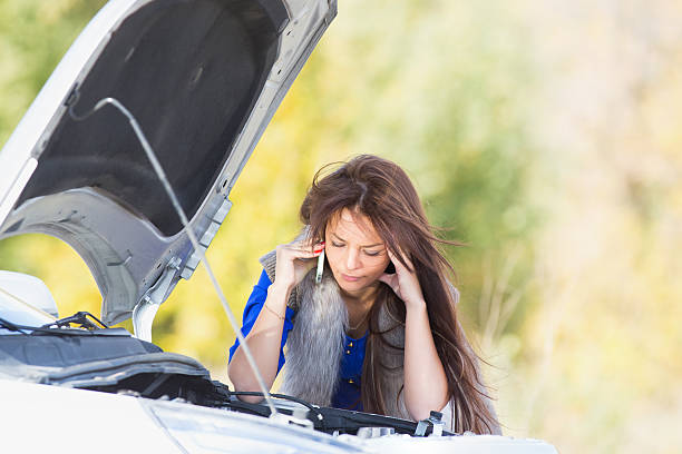 istock woman with a broken car 525831091