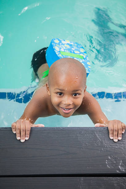 istock Little boy smiling in the pool 525831673