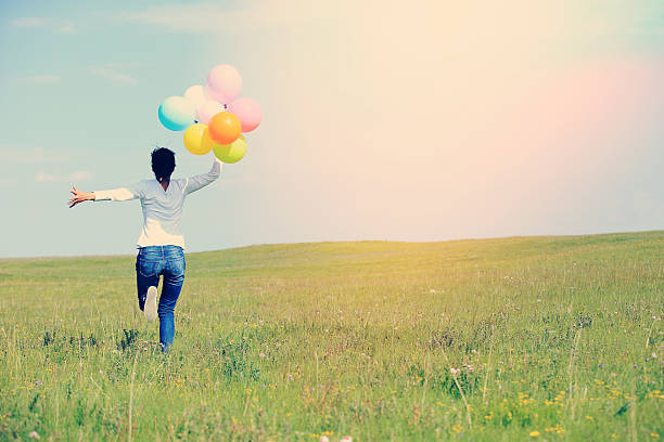istock young asian woman  with colored balloons 525831685