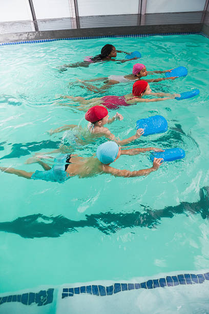 istock Cute little kids in the swimming pool 525832033