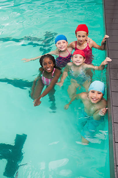 istock Cute little kids in the swimming pool 525832039