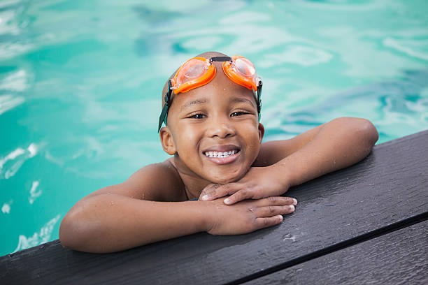 istock Little boy smiling in the pool 525832229