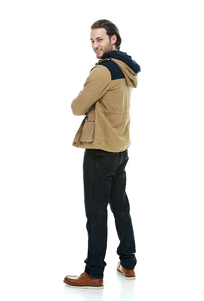 istock Rear view of man standing with arms crossed 525832855