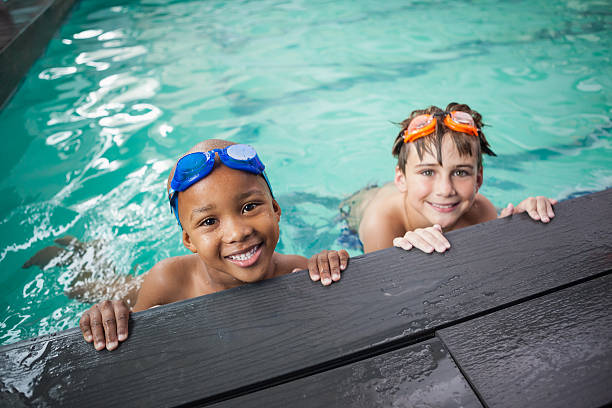 istock Little boys smiling in the pool 525833671