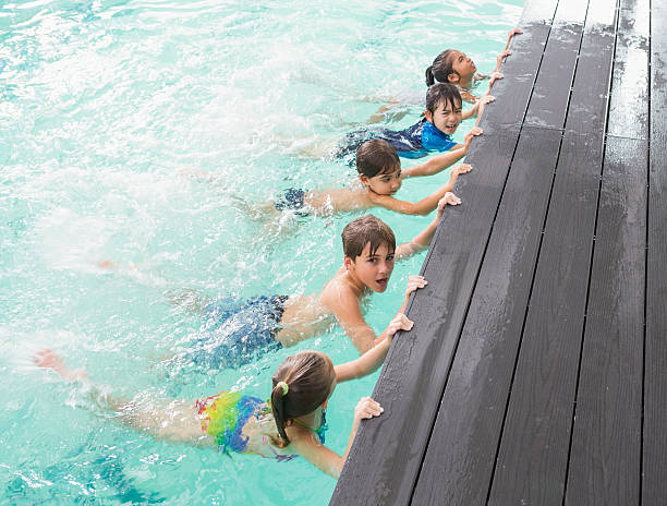 istock Cute swimming class in the pool 525834233