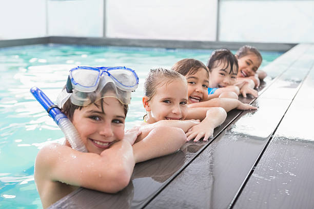 istock Cute swimming class in the pool 525834243
