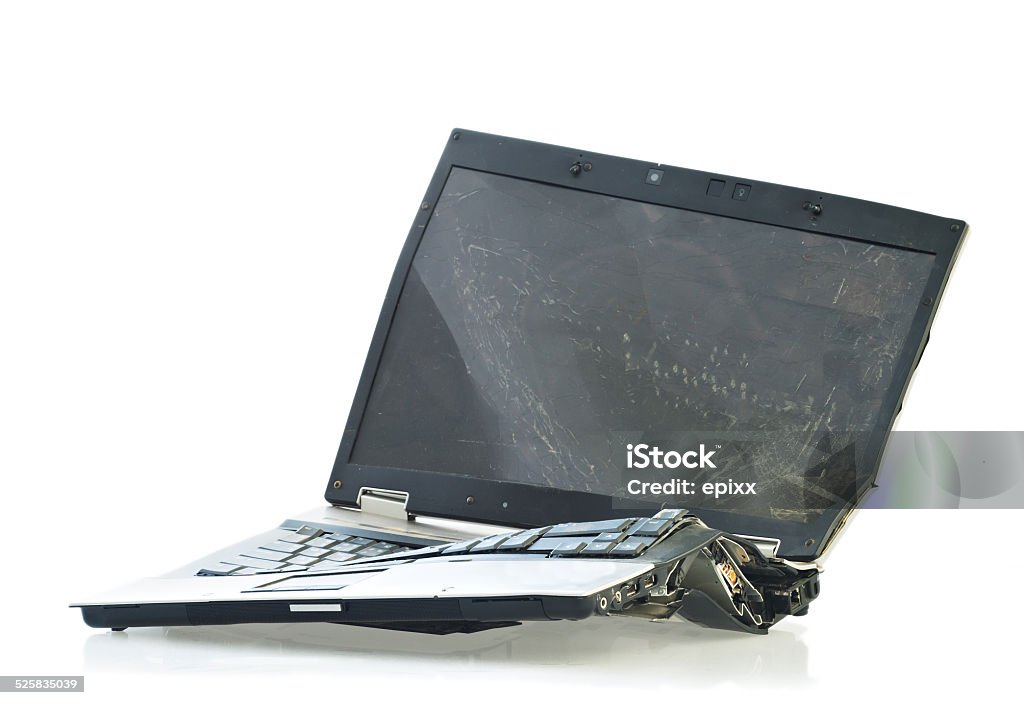 Broken laptop computer Laptop computer destroyed beyond repair in a car accident Broken Stock Photo